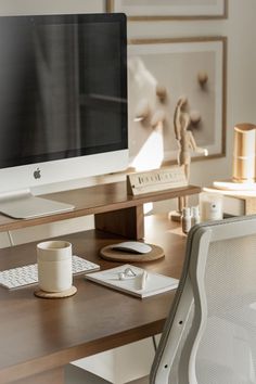 a computer monitor sitting on top of a wooden desk next to a keyboard and mouse