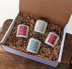 three candles in a box on a table