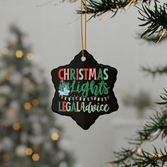 a christmas ornament hanging from a tree with lights and garlands on it