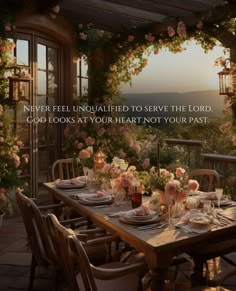 a table set with flowers and plates in front of an open window that says, never feel unhappled to serve the lord god looks at your heart not your past