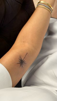 a woman with a spider tattoo on her arm