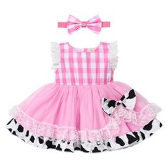 a pink dress with black and white polka dots on it