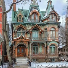 an old victorian style house in the winter