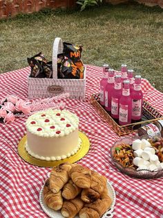 a table topped with cakes and pastries on top of a red checkered table cloth