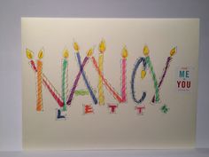 a greeting card with candles and the words happy new year written in multicolored letters