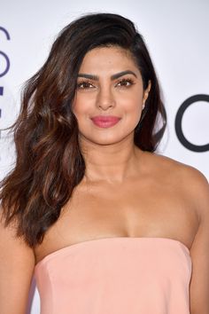 an image of a woman with long hair wearing a strapless dress and pink lipstick