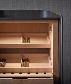 an open wooden cabinet with several pairs of shoes in the bottom shelf and two rows of drawers below