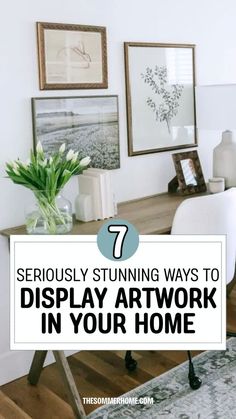 a desk with flowers and pictures on the wall in front of it that says, 7 seriously stunning ways to display art work in your home