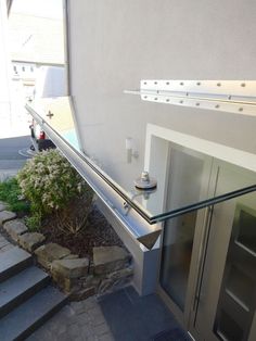 a glass railing on the outside of a house