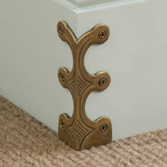 a close up of a door handle on a carpeted floor in front of a white box