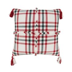 a red and white plaid pillow with tassels