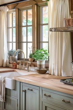 a kitchen filled with lots of windows next to a sink and counter top under a window