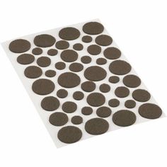 a sheet of brown polka dot stickers on top of a white surface with black dots