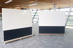 two white and black panels in an empty room