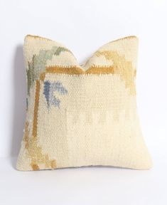 a decorative pillow with palm trees on it