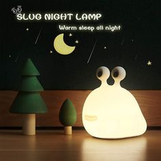 a night lamp with two eyes on it and the words sleep night camp written below