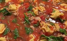 a bowl filled with pasta and spinach soup