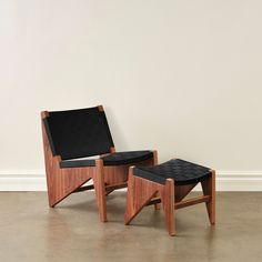 two wooden chairs sitting next to each other on top of a hard wood floored floor