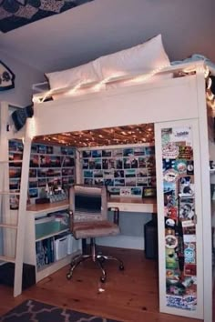 a white loft bed with a desk underneath it and lots of pictures on the wall