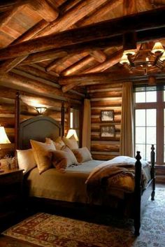 a large bed sitting in a bedroom next to a window covered in wood planks