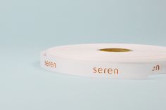 a white ribbon with an orange print on it that says, seren 2n