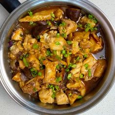 a bowl filled with meat and vegetables on top of a table