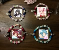 three bracelets with anime characters on them sitting on a table next to other items