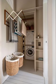 a washer and dryer in a laundry room next to a shelf with towels