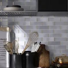 kitchen utensils and cookbooks are sitting on the counter