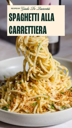 spaghetti with parmesan cheese being lifted from a white bowl