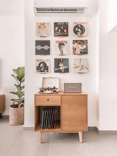 a record player sitting on top of a wooden cabinet