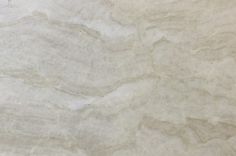 a white marble textured surface with light brown veiners on the top and bottom