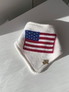 an american flag knitted on top of a bed