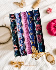 four different types of decorative paper on a white surface with flowers and butterflies around it