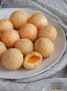 sesame seed balls are on a white plate