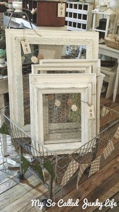 three white frames sitting on top of a wooden floor