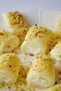 some food on a white plate with sprinkles and seasoning around it