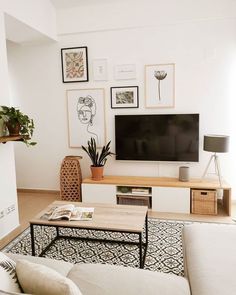 a living room filled with furniture and a flat screen tv mounted on a wall above a wooden coffee table