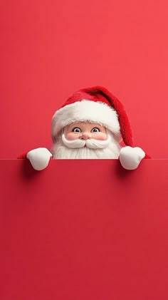 santa claus peeking out from behind a red board