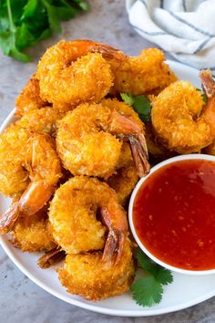 fried shrimp with dipping sauce on a plate