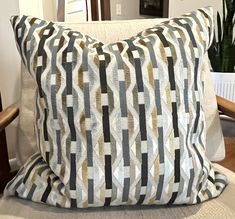 a pillow sitting on top of a wooden chair