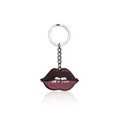 a close up of a keychain with a mouth on the front and tongue on the back