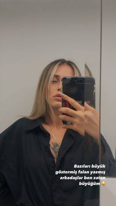 a woman taking a selfie in front of a mirror