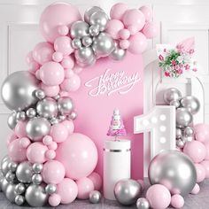 a pink and silver birthday party with balloons