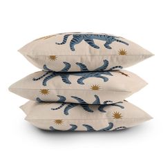 three pillows stacked on top of each other with blue and gold cats printed on them