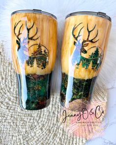 two wooden cups with deer images on them