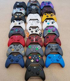 a bunch of video game controllers lined up on the floor