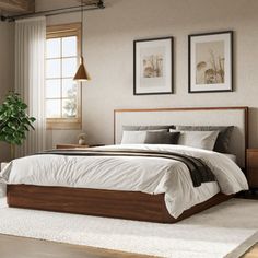 a bedroom with a bed, dresser and two pictures on the wall above it that have plants in them