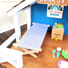 there is a dollhouse bed and toys on the floor