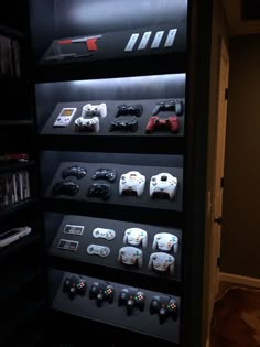 there are many video game controllers on display in this room, and one is lit up